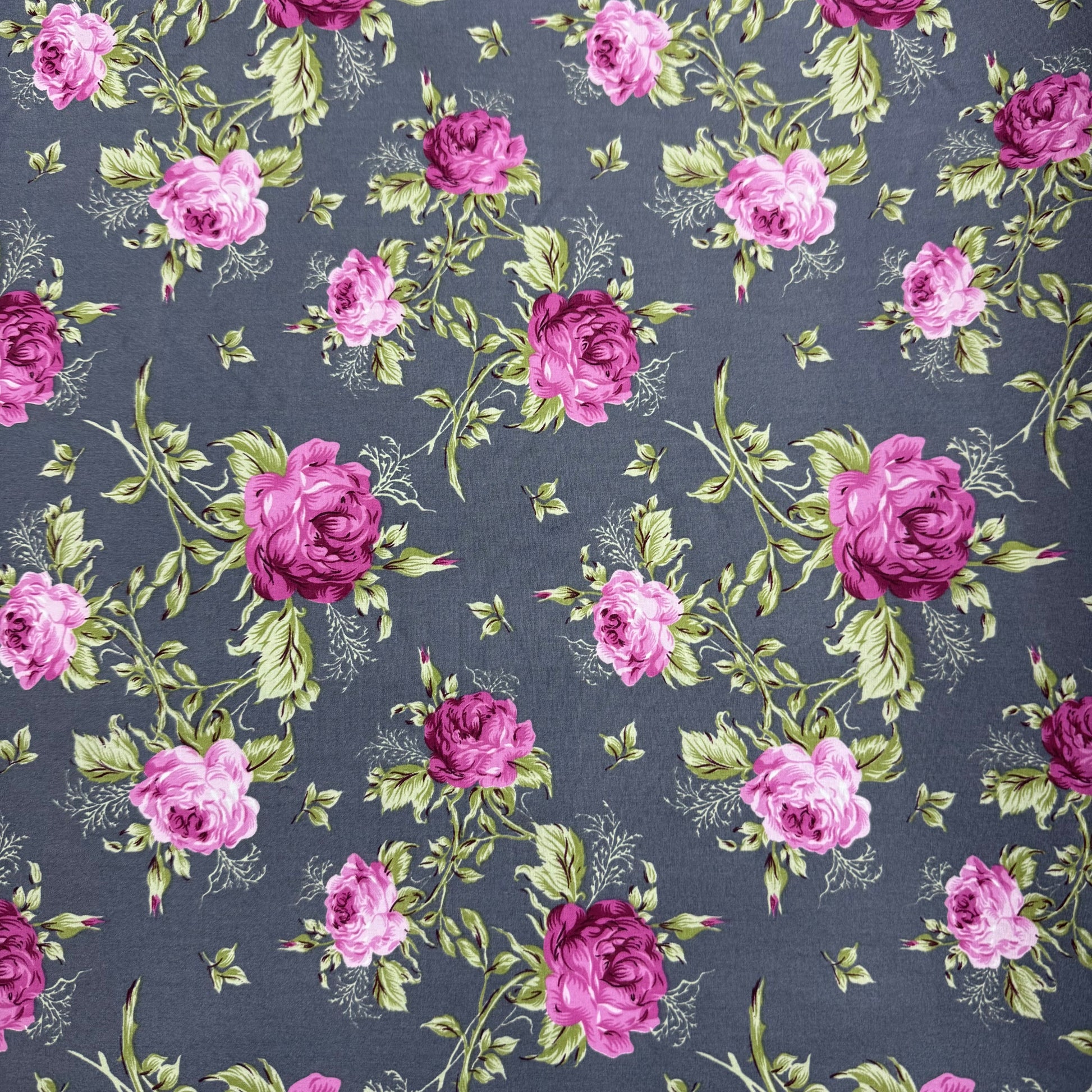 Pattern of pink and purple roses on a dark blue background